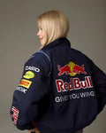 Person wearing a navy jacket with Red Bull and other brand logos back view