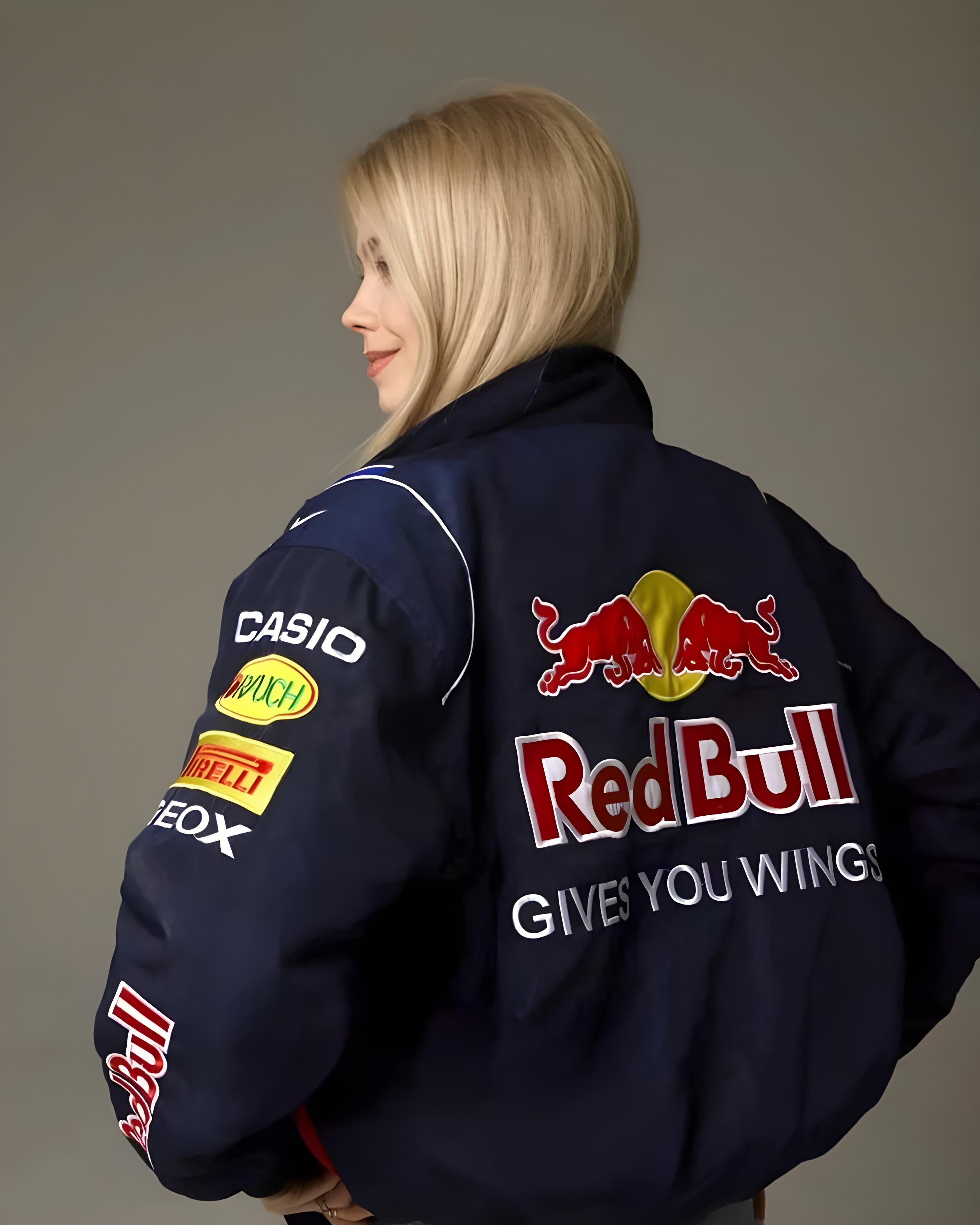 Person wearing a navy jacket with Red Bull and other brand logos back view