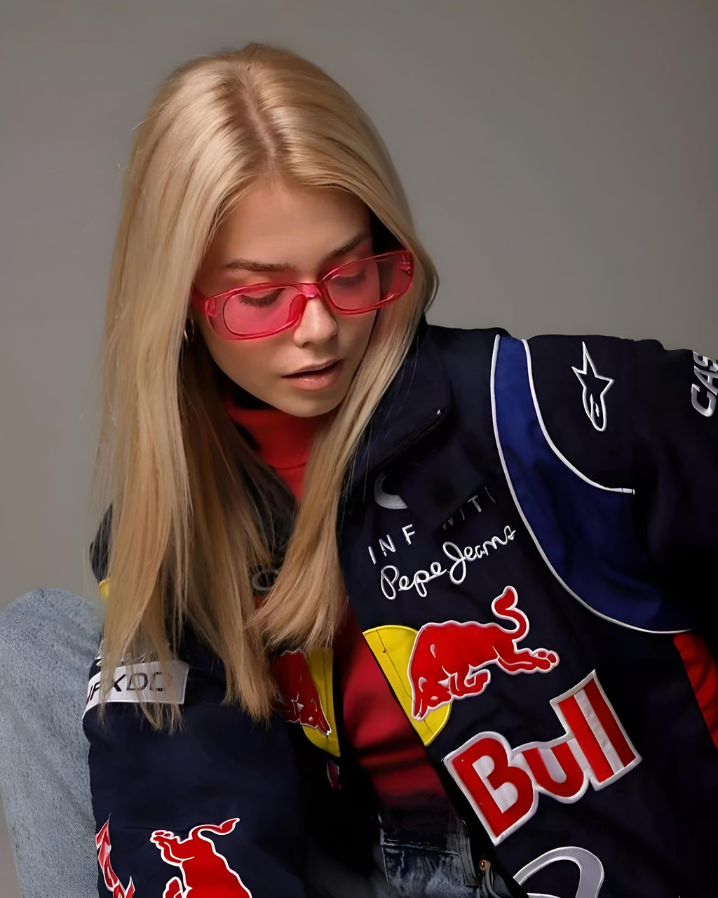 Person wearing a jacket with Red Bull logo and Pepe Jeans branding closeup view
