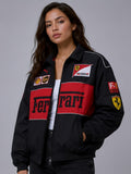 Front view of female model styling WALHALAA women's black vintage ferrari racing jacket made of parachute fabric